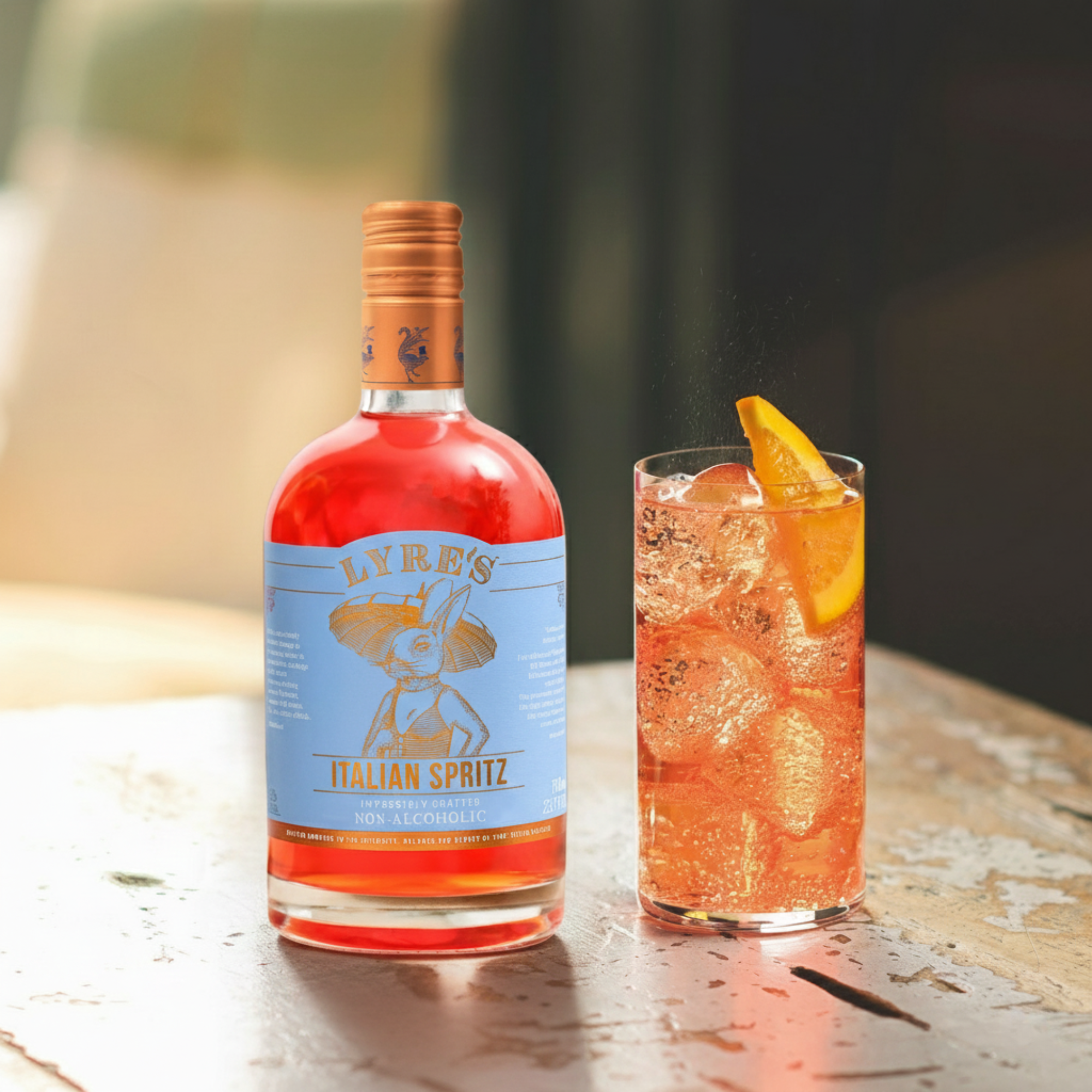 Bottle of Lyres Italian Spritz with a glass of spritz on a wooden surface